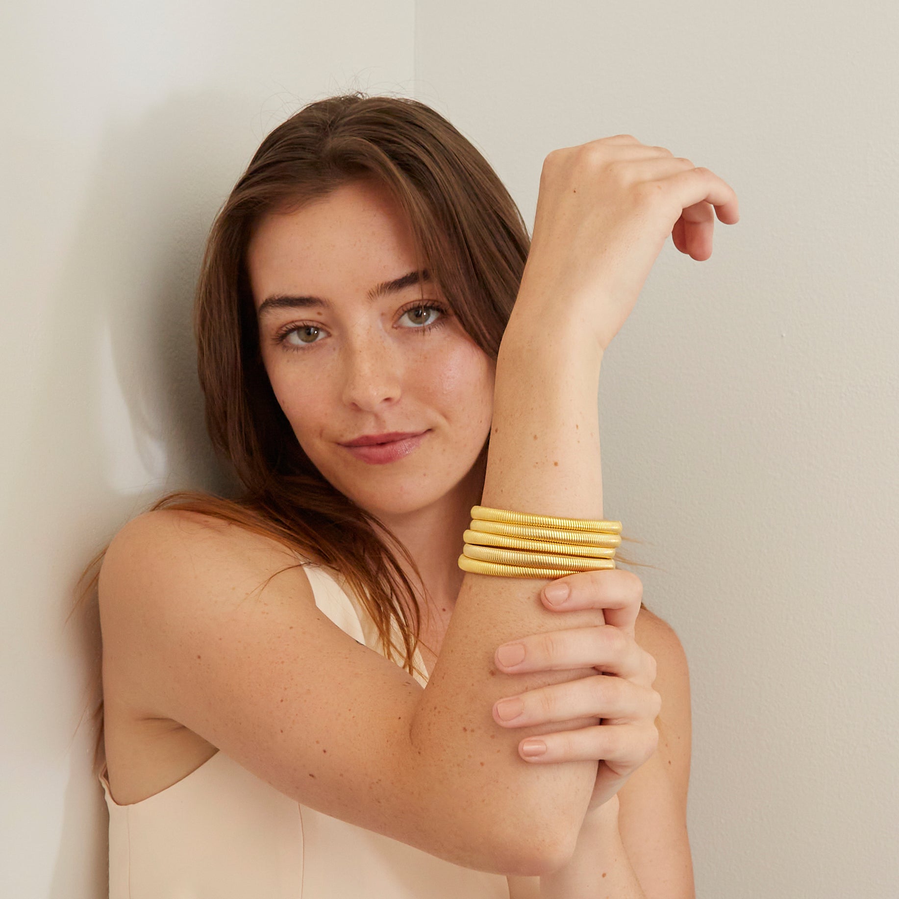 woman wearing five gold bangles