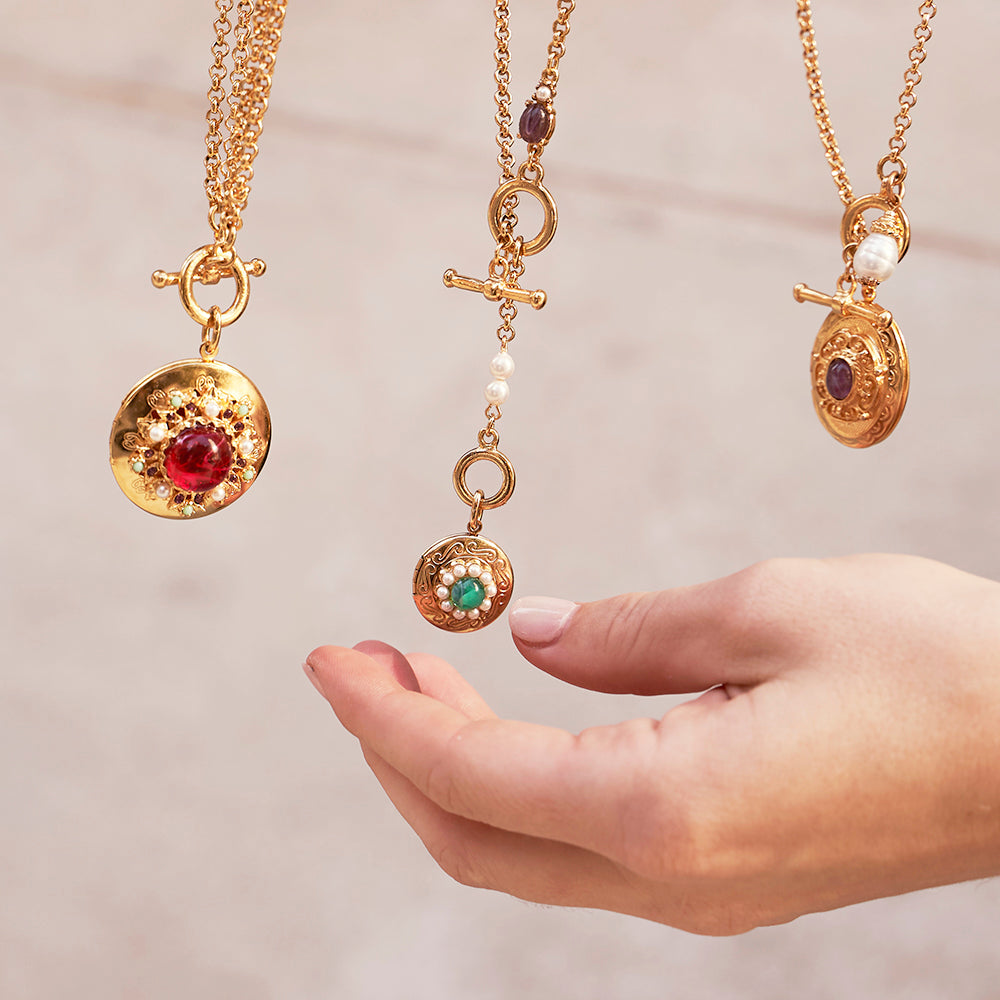 model holding three dangling charm nekclaces with resin, czech glass stones, and majorca glass pearls 